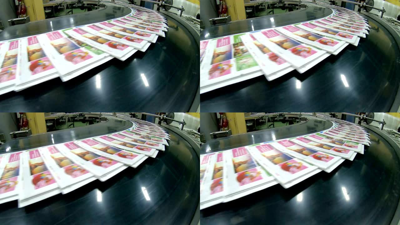 印刷厂工厂，杂志在印刷单元和文件夹后在传送带线上运输