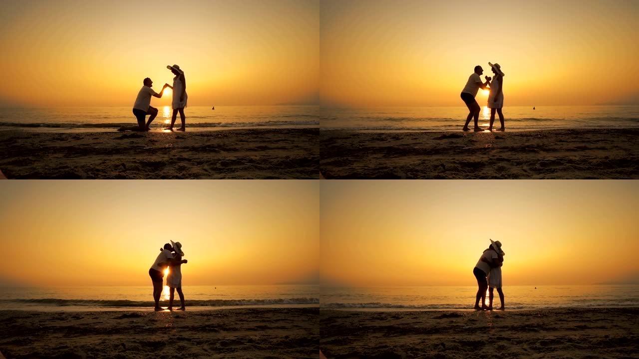 一名男子在日落时在海滩上求婚，慢动作