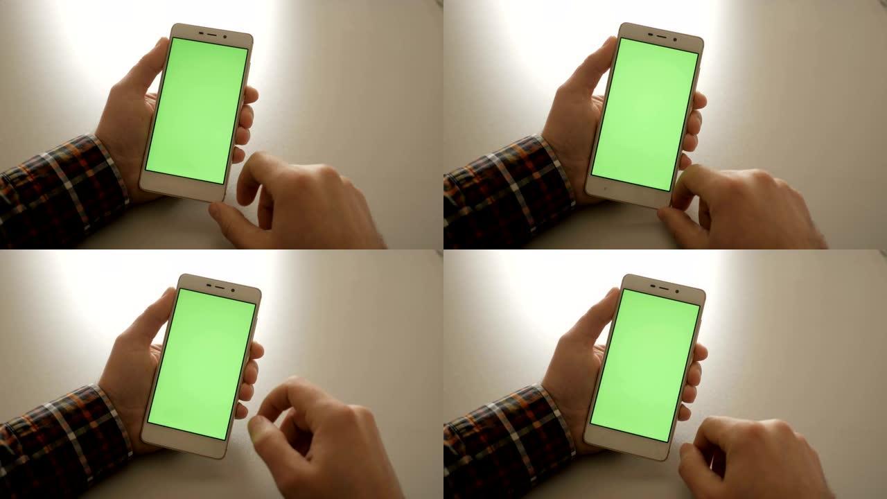 男性手里拿着智能手机的绿屏绿屏，男性手里拿着手机的智能手机，色键绿屏白底。男人用手机。