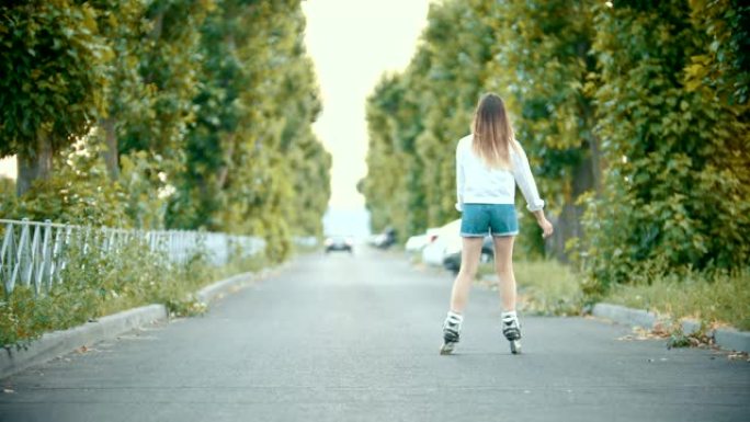 一个穿着旱冰鞋的少女在路上滑冰