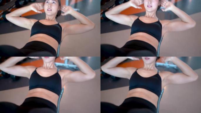 专业美丽的亚洲女性锻炼在健身馆做仰卧起坐运动健康的生活方式，运动员腹肌肌肉强健，适合身体4k分辨率。