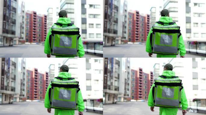 后面的镜头是年轻的食品快递员穿着绿色制服走在街上，带着隔热背包运送食物，手里拿着手机，向左复印空间