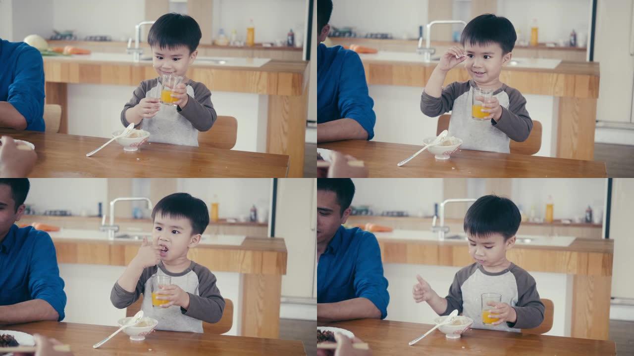 亚洲小男孩吃米饭喝果汁
