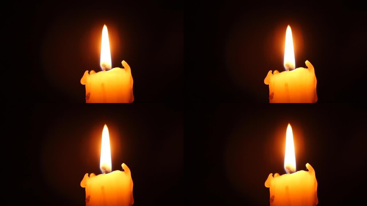 黑色蜡烛火焰特写。旧白色蜡烛