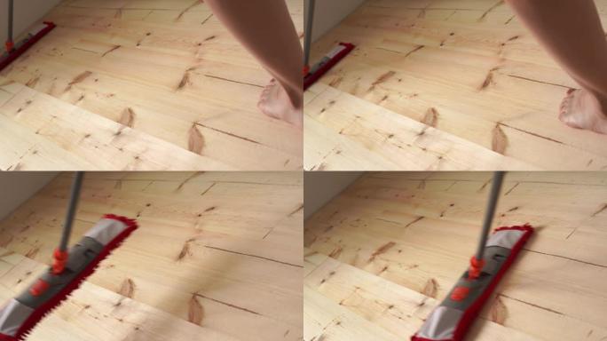 环保涂料。房屋清洁。赤脚女人拖把木地板