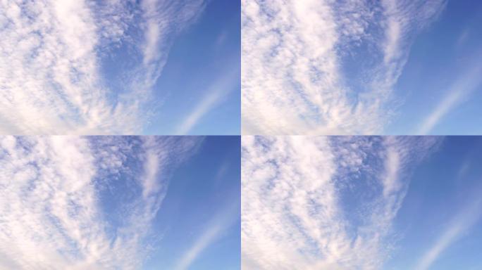 蓝色的天空有一个美丽的白云团，带有空间的副本。鸟儿向南飞