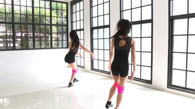 慢动作侧视图: 可爱的女孩舞者和她的朋友用强烈的手势练习爵士舞