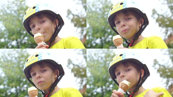 戴着头盔的男生吃冰淇淋，看着相机