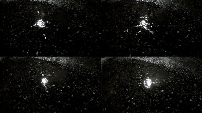 凉爽寒冷潮湿的雨季，晚上有倒影的小街池塘里有雨滴的概念