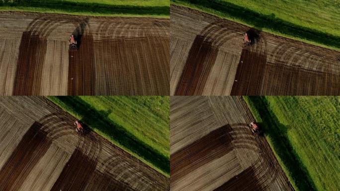 带双轮的红色拖拉机用圆盘耕耘机处理棕色土壤