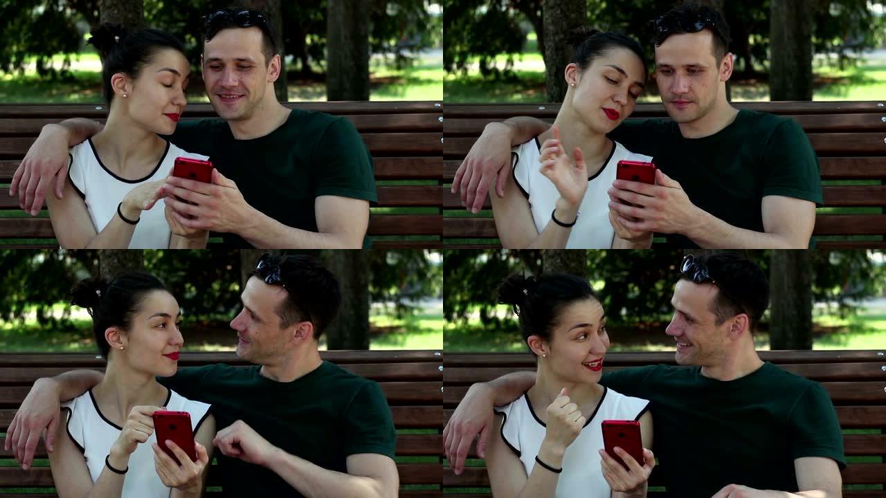 在阳光明媚的日子里，年轻的情侣正坐在公园的长椅上，积极讨论一款新的智能手机。