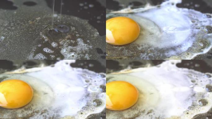 平底锅煎鸡蛋。碎鸡蛋掉进煎锅