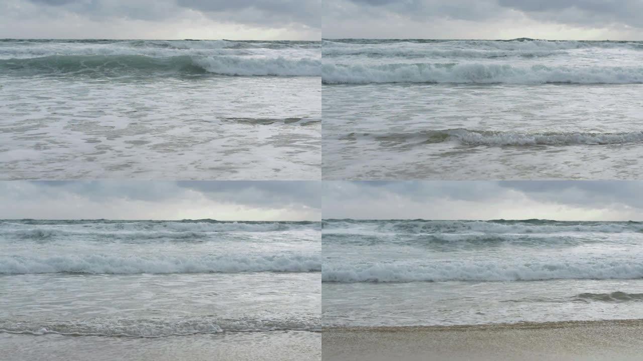 海水的慢动作，大海浪在雨云天空下溅起海滩。