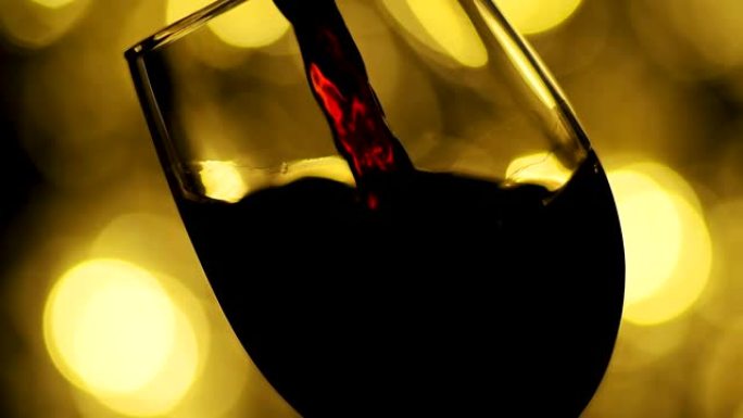 红酒从瓶子里倒出来。侍酒师将优质的玫瑰酒倒入玻璃杯中。