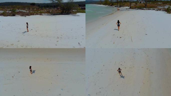 妇女在布克岛上的蓬塔·塞巴林 (punta Sebaring) 的无尽白色沙滩上行走的空中镜头