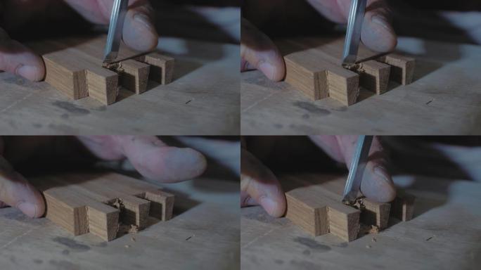 特写镜头，木工在工作台上用凿子在木制零件上做燕尾榫。木匠加工橡木坯料。4k. 4k视频。慢动作。24