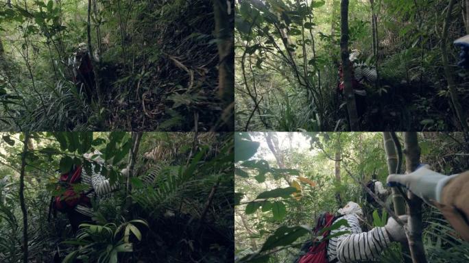 背着背包的徒步旅行者在亚洲丛林中的艰难道路上旅行。