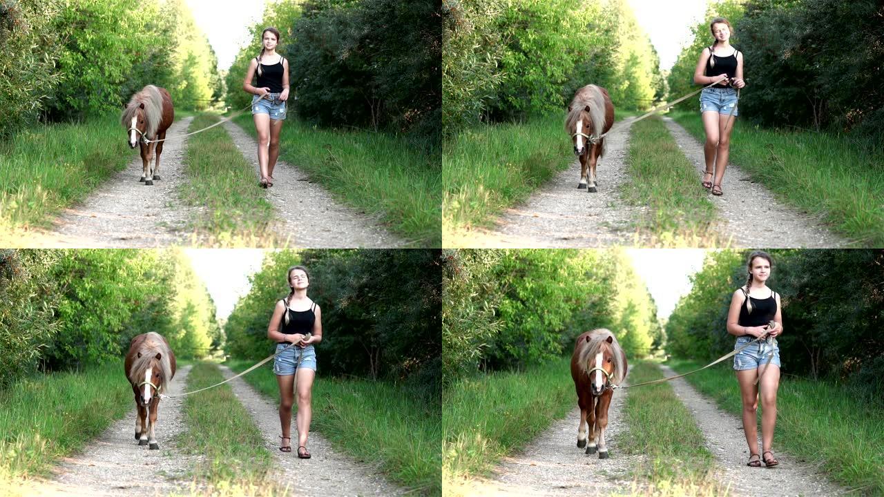 十几岁的女孩在夏天沿着美丽的乡间小路散步