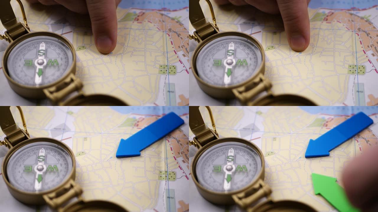 带有指南针背景的男性手在地图上搜索方向