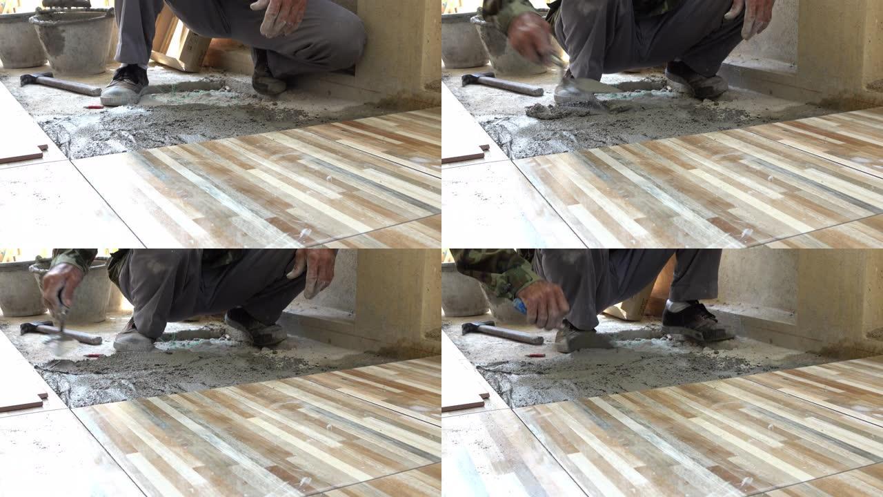 建筑工人使用油灰刀瓷砖地板