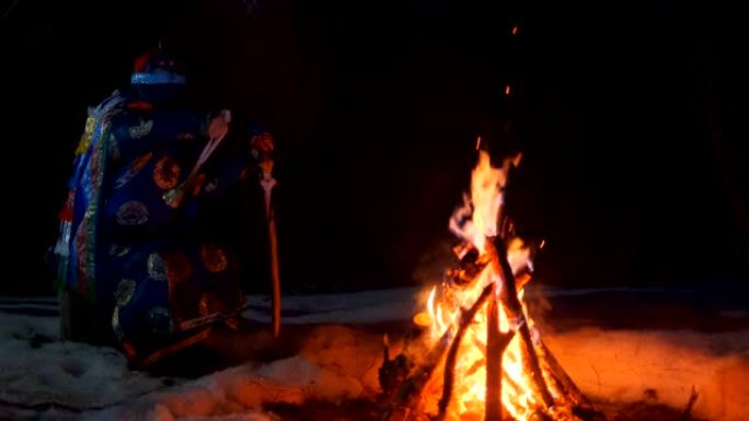 萨满在夜晚的篝火旁进行仪式