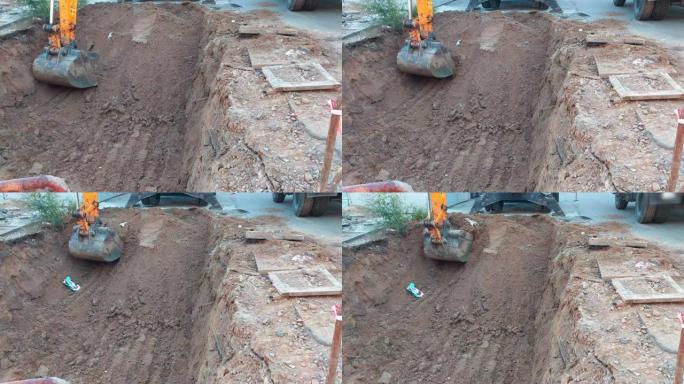 挖掘机铲斗在施工现场挖洞
