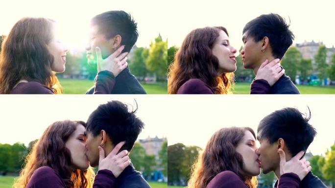 年轻的亚洲高加索夫妇在日落时在公园接吻和亲热，阳光照在后面