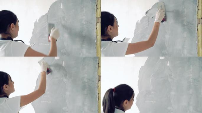 年轻女子在公寓或房子里画墙漆。