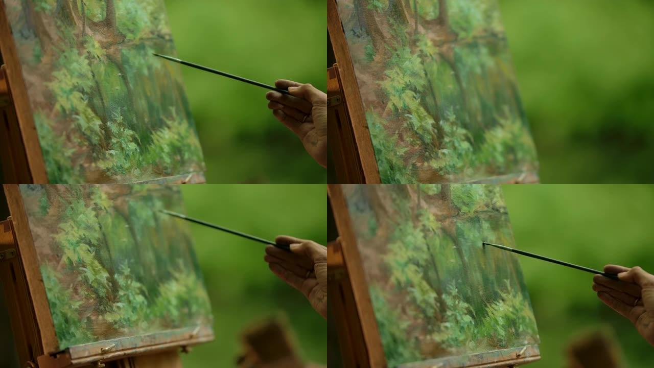 一位女士的手的特写一位画家用画笔画龙点睛