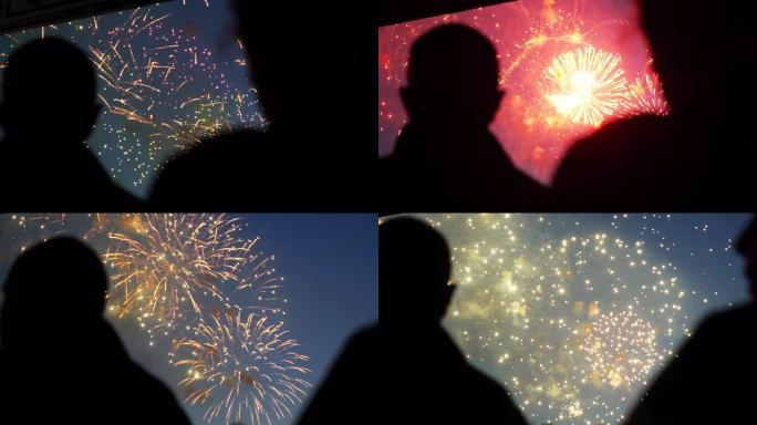 剪影的人看站烟花特写背景的夜空4K。