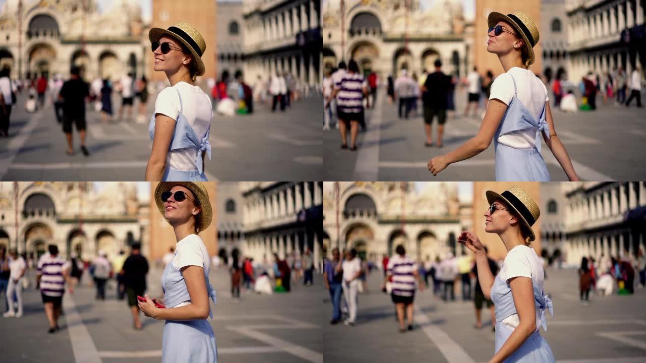 穿着时尚服装的快乐开朗女游客的慢动作在浪漫的城市威尼斯度过暑假，漫步在著名的历史悠久的圣马可广场
