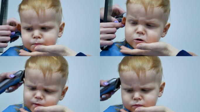 理发师用电动理发剪小男孩的头发