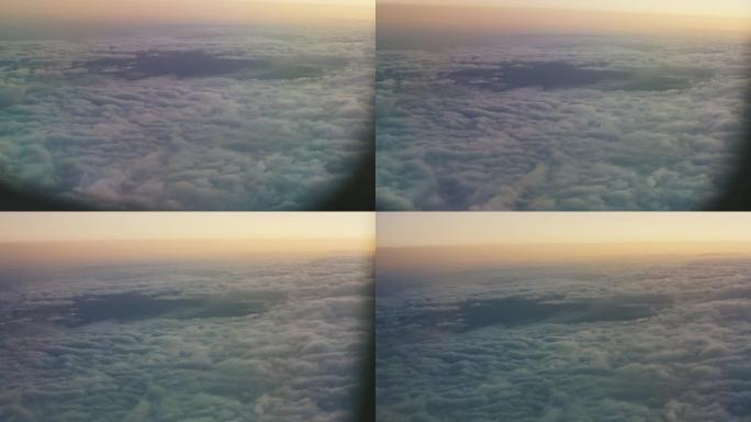 从飞机的窗户看。飞机在地面和云层上飞得很高。从舷窗观看
