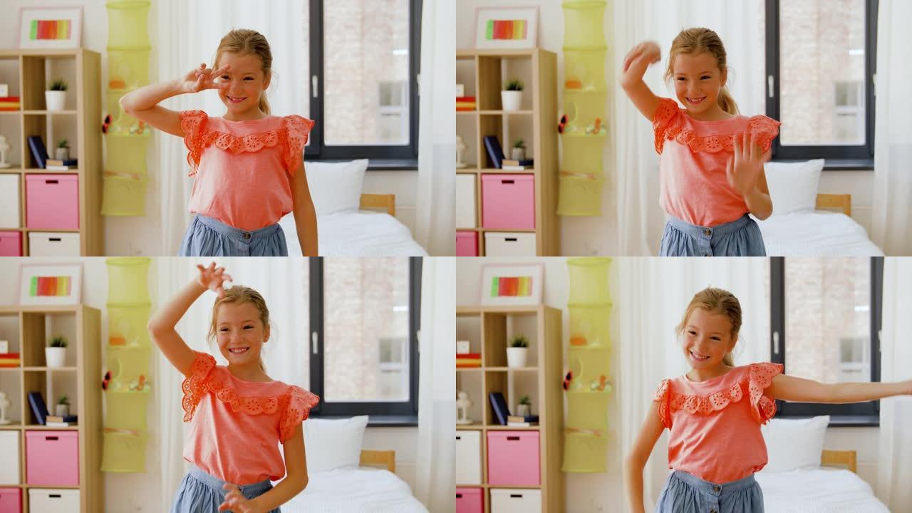 快乐的小女孩在家里的房间里跳舞