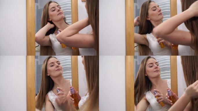女人照顾她的长发涂化妆油。4K