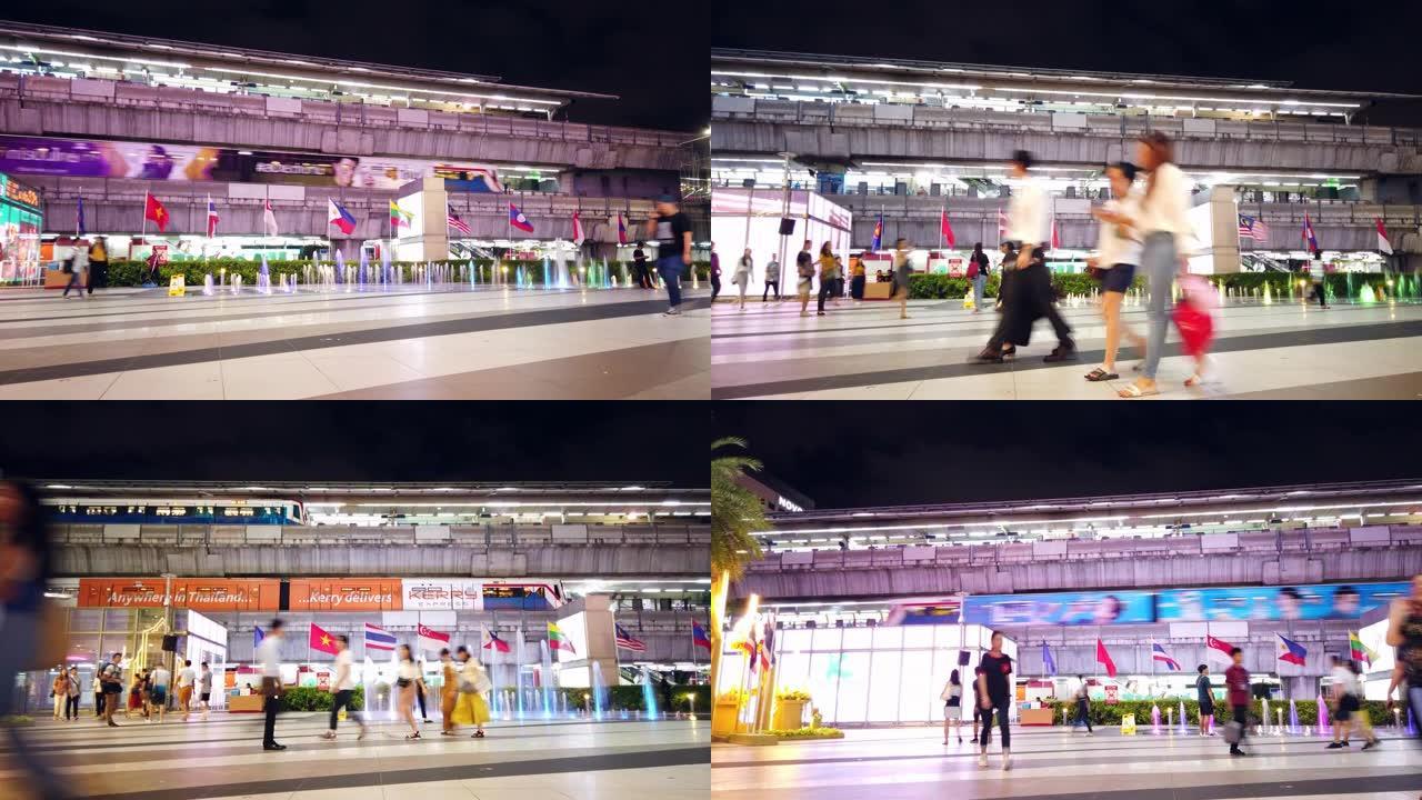 夜间步行人群在BTS天空火车站附近的中央人行道上行走