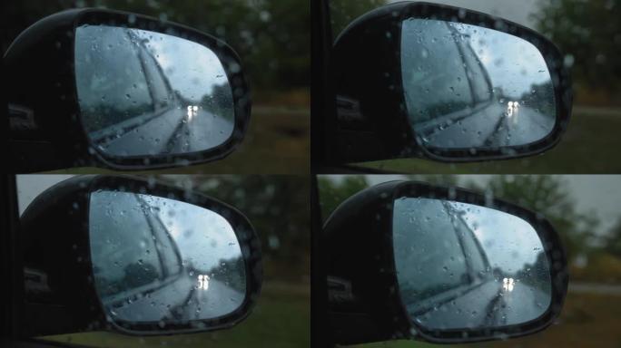 汽车在大雨中行驶的侧镜视图