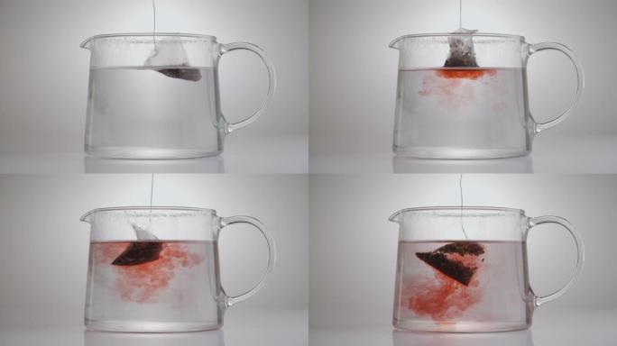 茶包浸泡在玻璃壶中的特写演示视频。水果茶制作。
