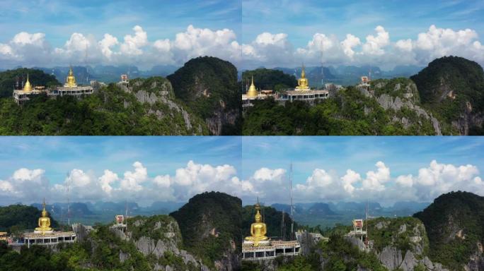 鸟瞰虎洞寺，泰国甲米的Wat Tham Seua的蓝天顶上的佛陀