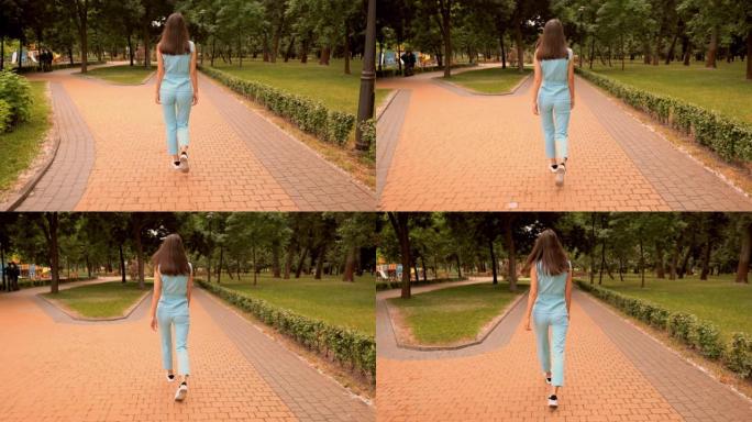 后视图愉快的白人妇女走在街道上的城市公园