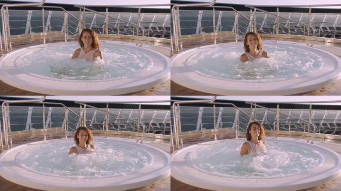 女人在豪华度假村的热水浴缸按摩浴缸户外放松