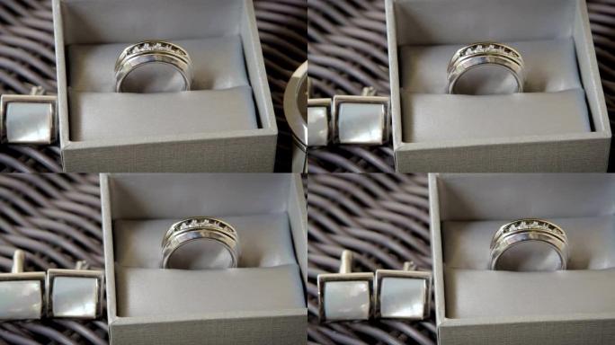 新郎的银色结婚戒指和袖扣的滑动镜头