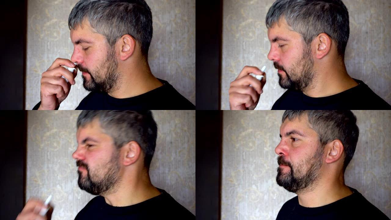 一个留着胡子的不健康的人在鼻子里吃药