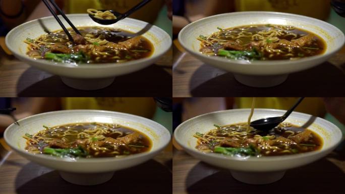 4K，亚洲妇女用棍子吃牛肉面，餐厅中餐