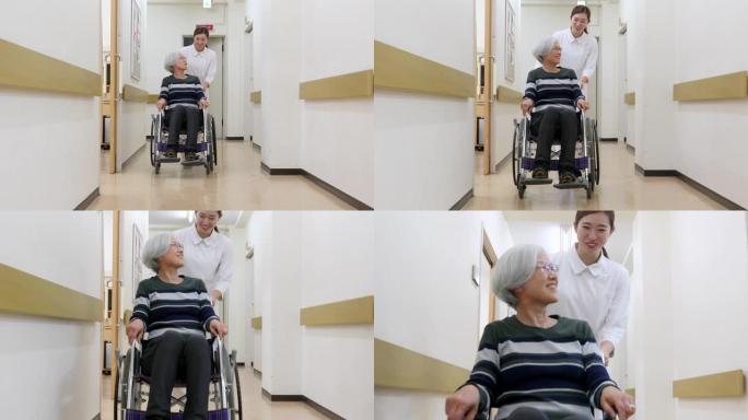 护士推着轮椅上的高级患者通过医院