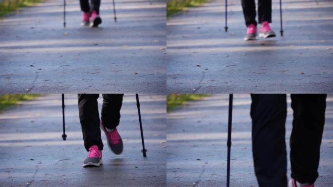 一个练习北欧行走的女孩的特写腿。她正向我们走来。慢动作。