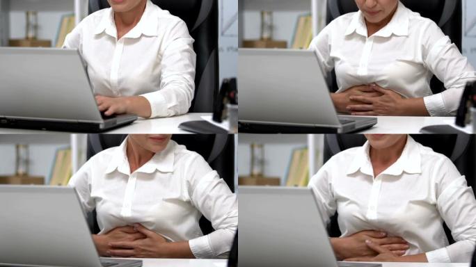女人在笔记本电脑上触摸腹部，胃炎问题，营养不正常