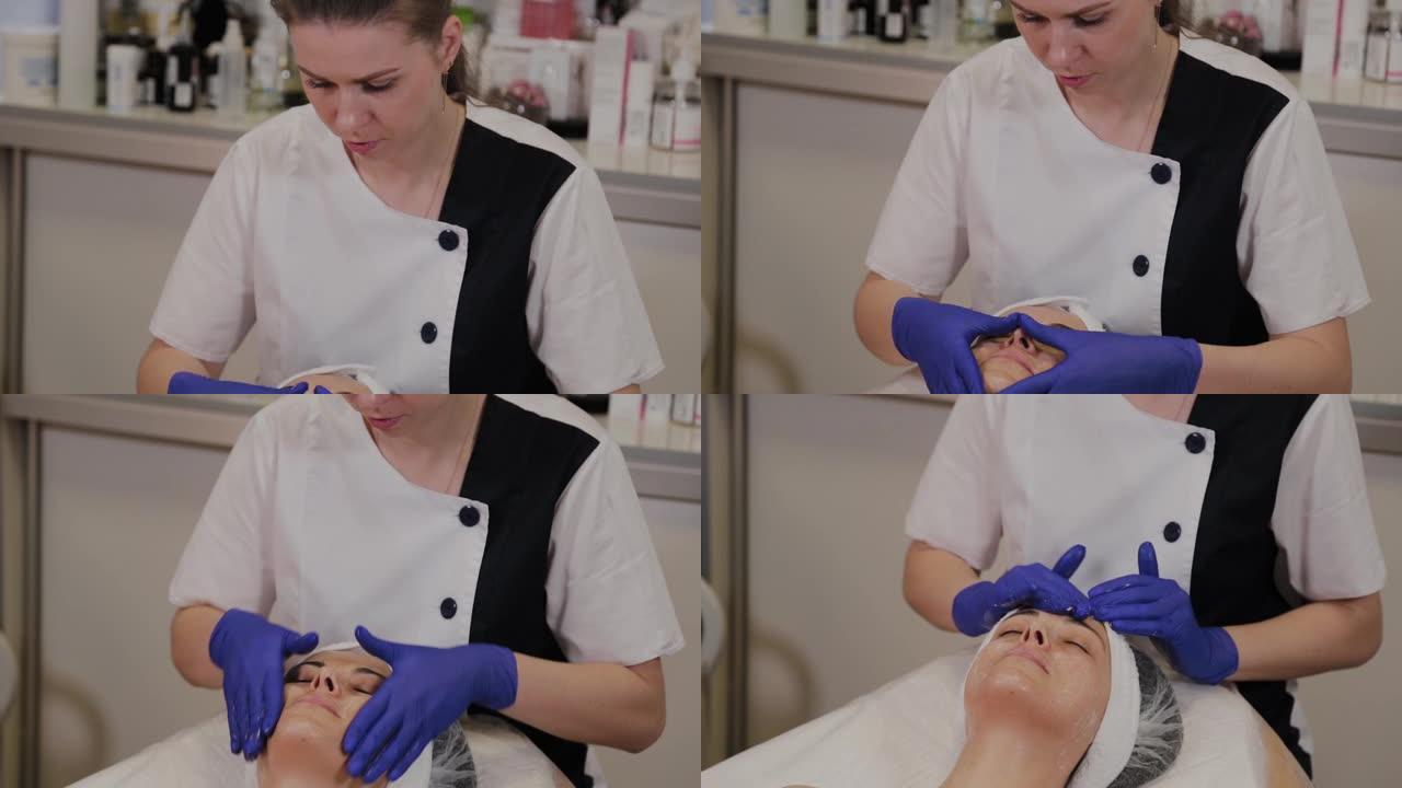 专业美容师用手按摩动作在女人脸上涂抹擦洗油