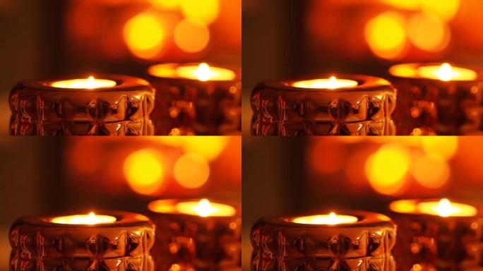 蜡烛的特写镜头，壁炉在背景中被点燃和模糊