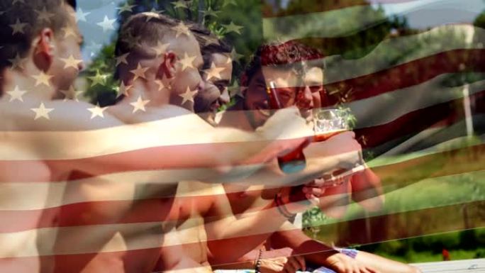 一群朋友在一个游泳池和美国国旗为7月4日